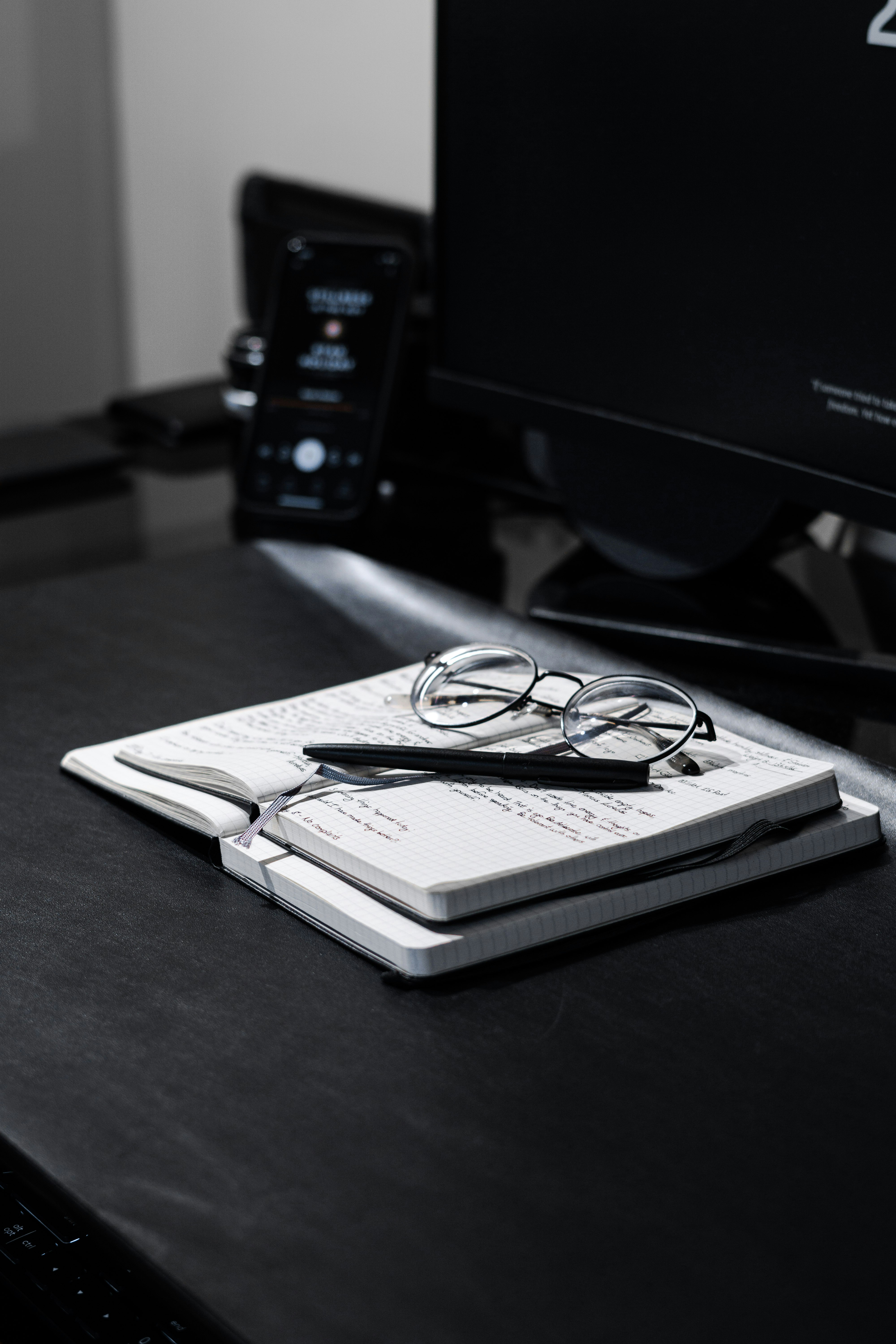 black framed eyeglasses on white paper